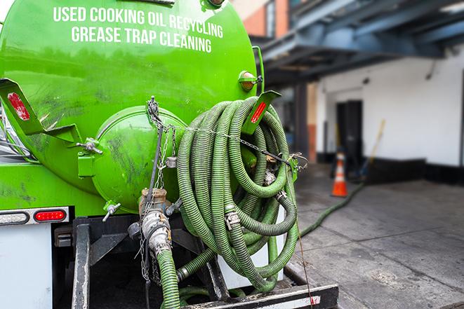 a vacuum truck pumping out a large underground grease trap in Depauw, IN